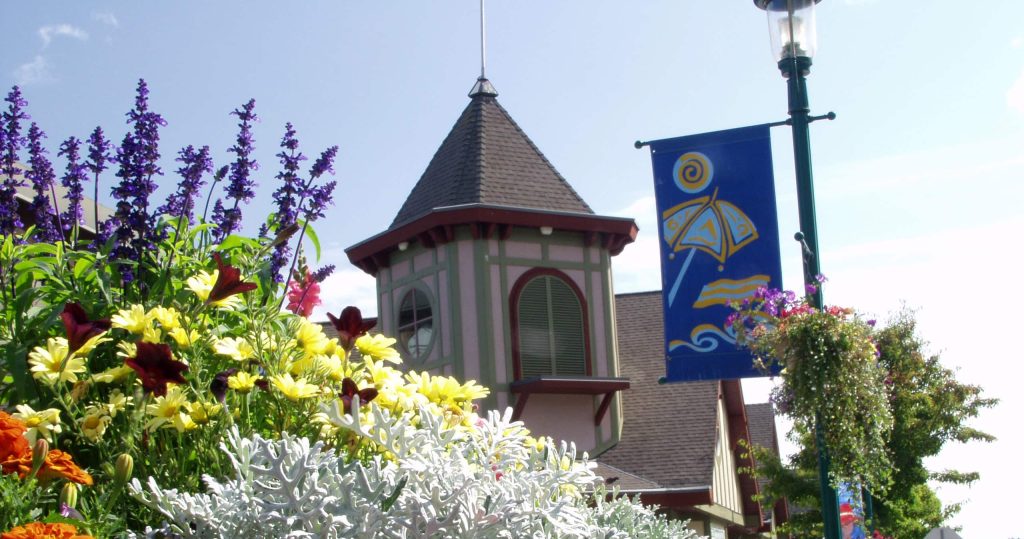 Street banner and flowers in front of building