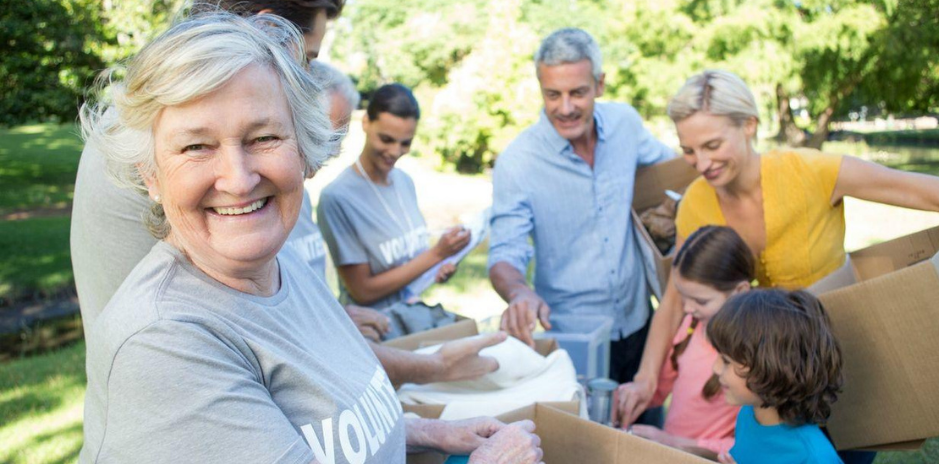 group of volunteers of various ages working on a project with volunteer tshirts