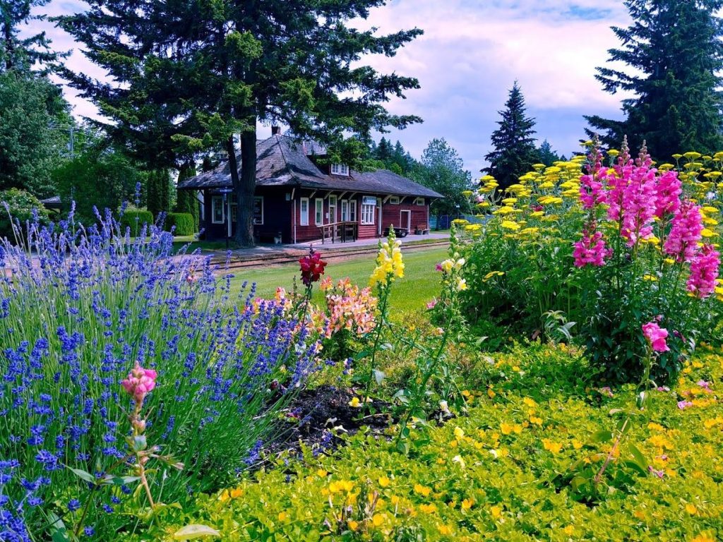 photo of flowers in front of the Train Station in Qualicum Beach