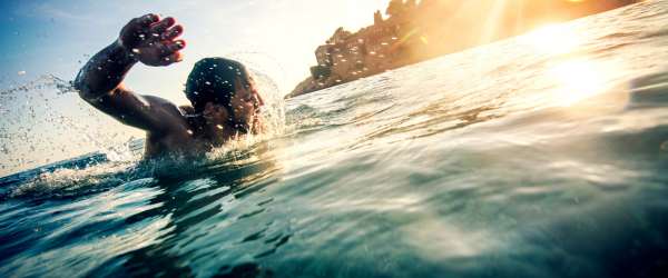 Ocean Mile Swim - young man swimming in the ocean