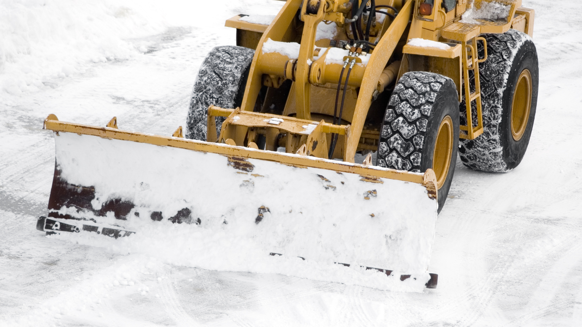 Tractor removing snow in a parking lot