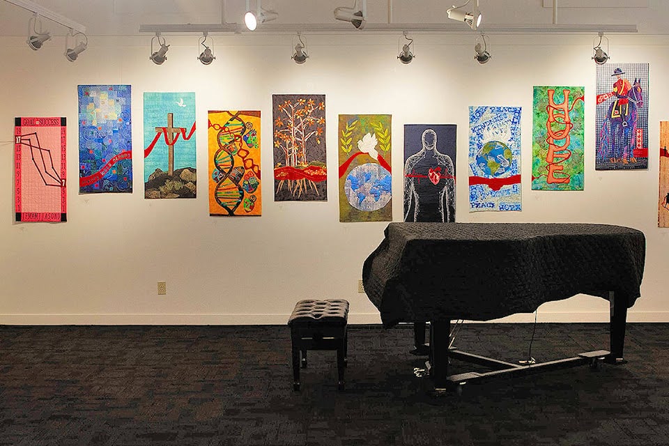 An art hall with several pieces of artwork displayed on the wall, and a piano visible in the frame.