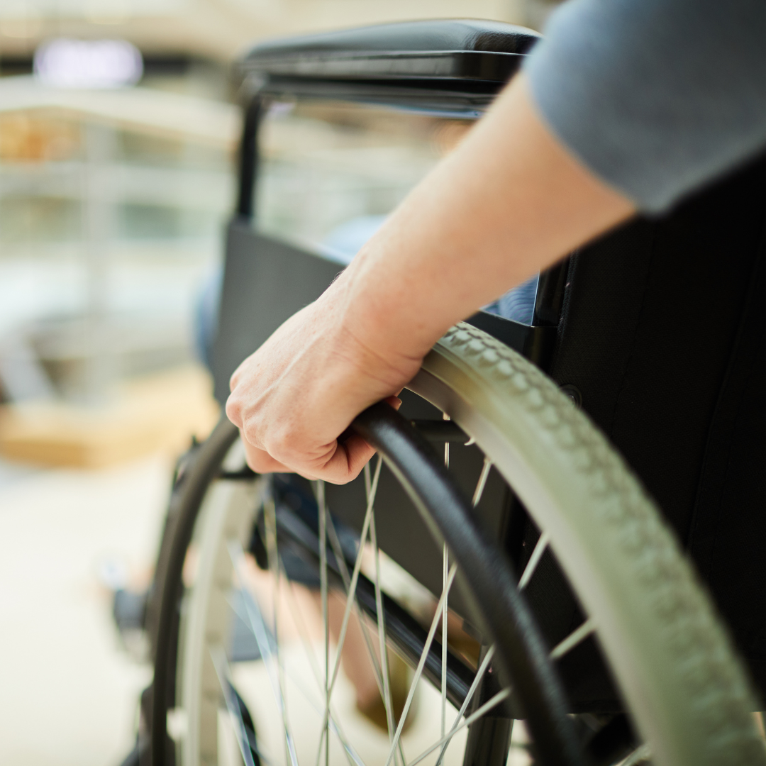 Close up of a wheelchair with a blurred background.