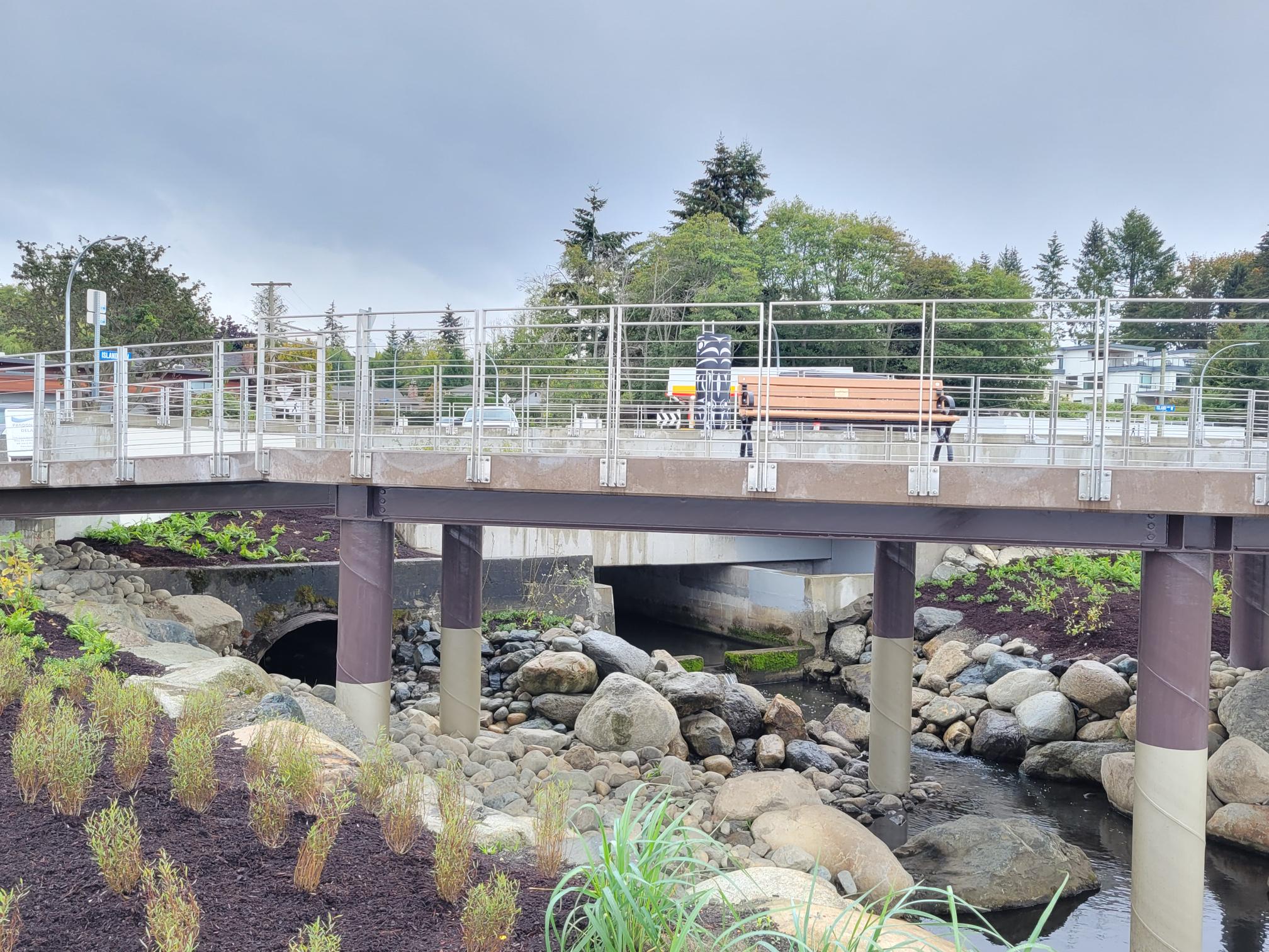 A far away angle of the Viewing Platform and Walkway, showing a bridge over a creek.