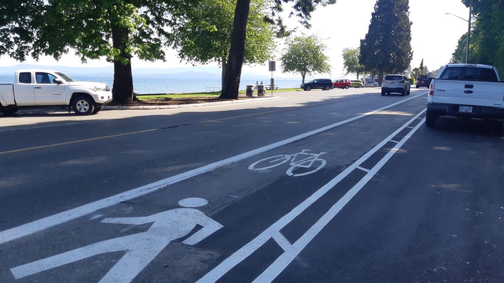 Bike and walking lane running along an oceanside road.